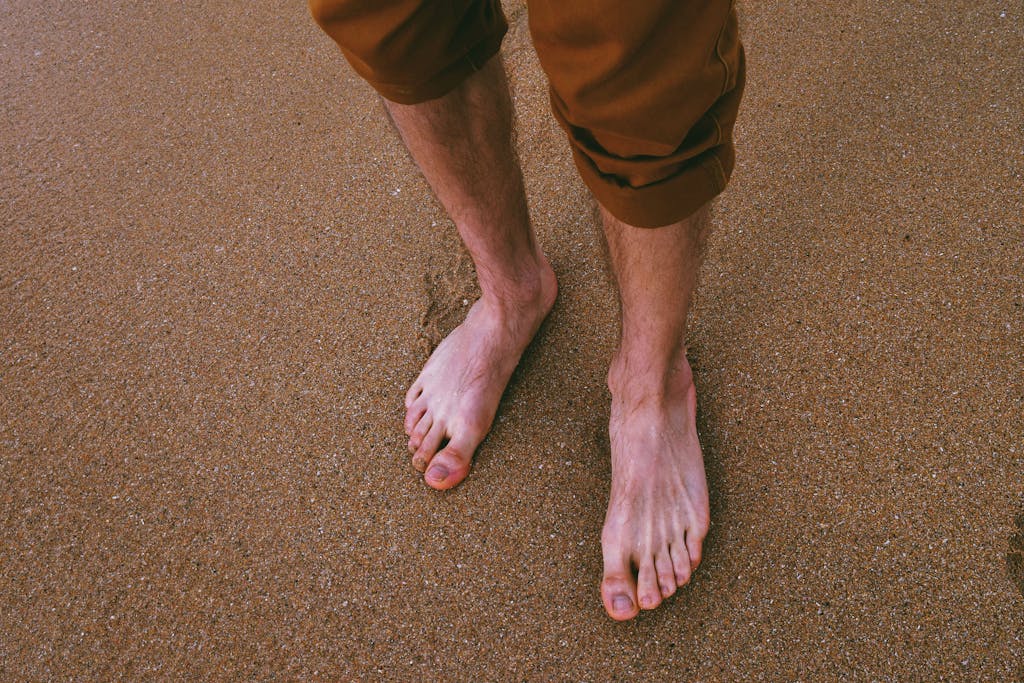 Close Up Photo of Person Standing on Seashore